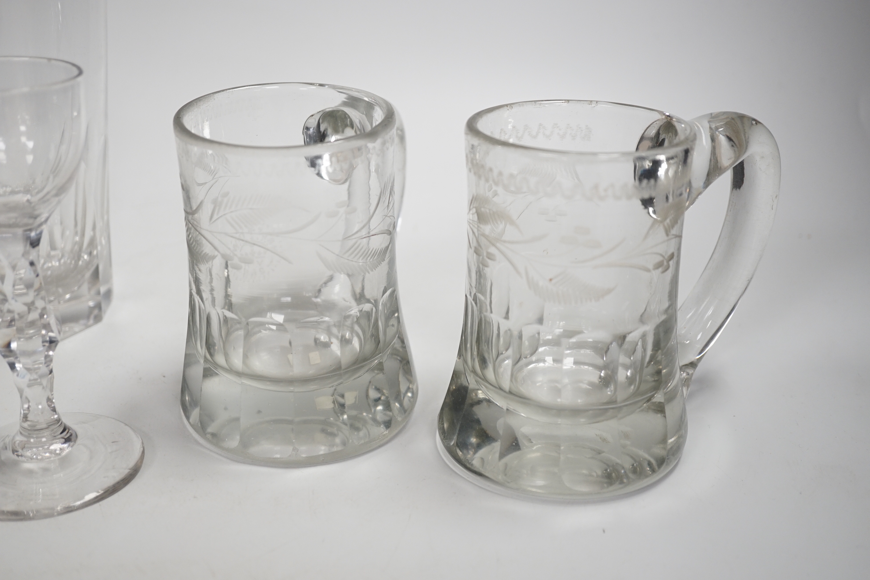 A pair of Victorian pub tankards, engraved with floral motifs and one acid etched with HALF PINT VR and Crown and the number 265, together with two 19th century faceted stem wine glasses, a trumpet glass and two large 19